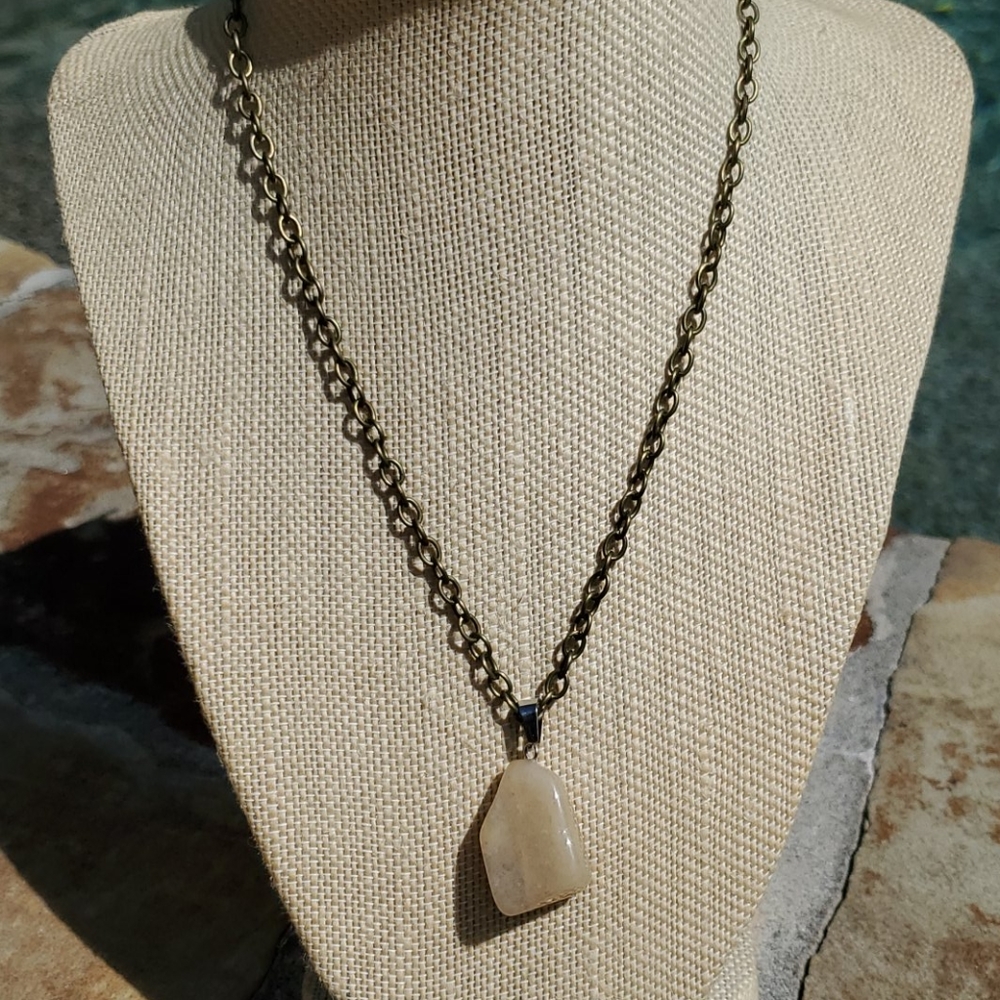 Bronze plated necklace with tan stone charm.
